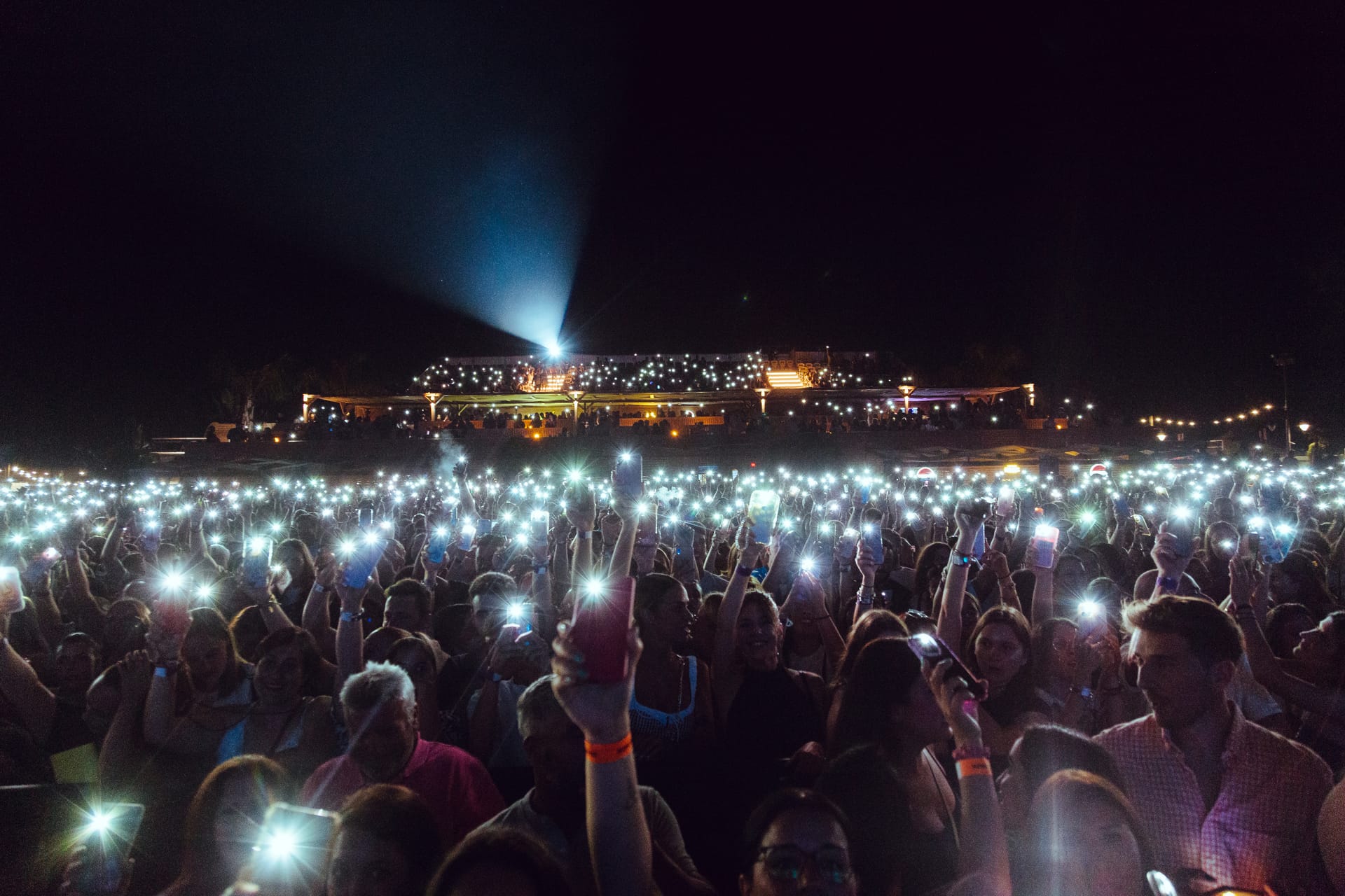 Crowd at an outdoor night concert with illuminated stage at Málaga Forum