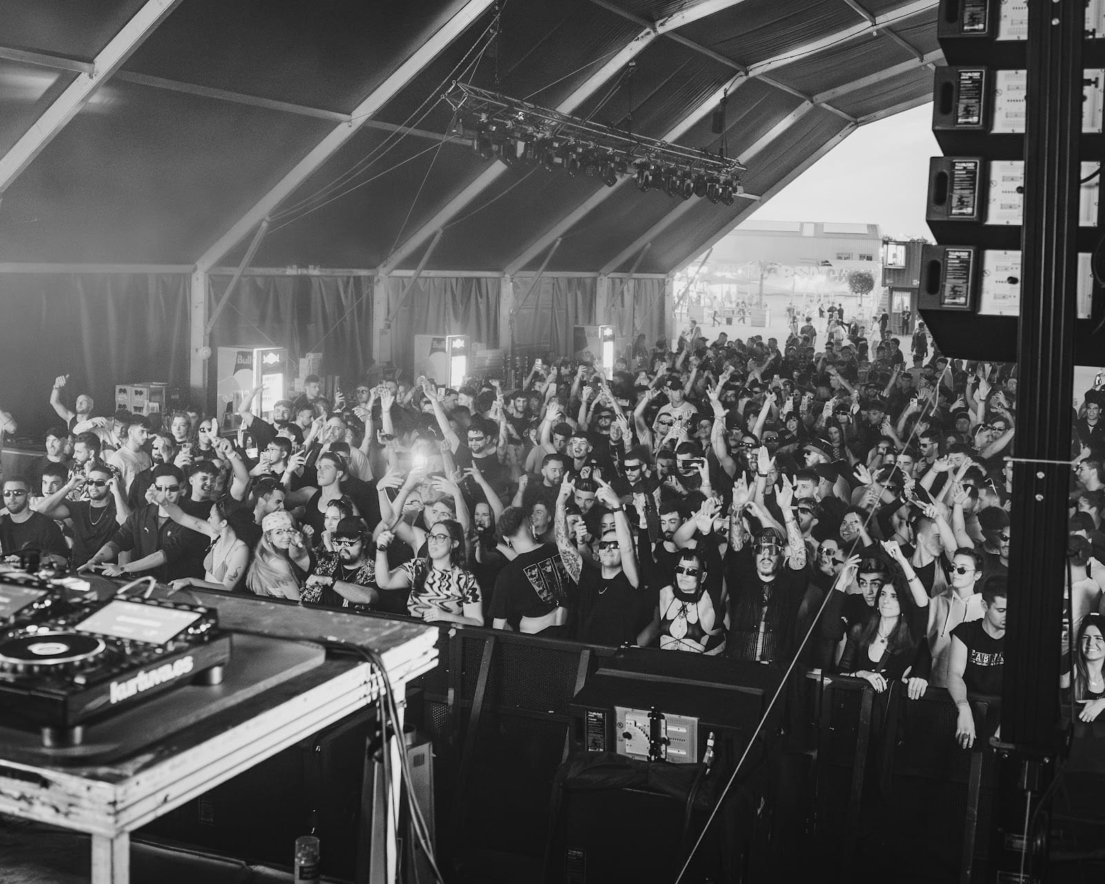 Corporate event with crowd, stage and audiovisual production in a covered venue