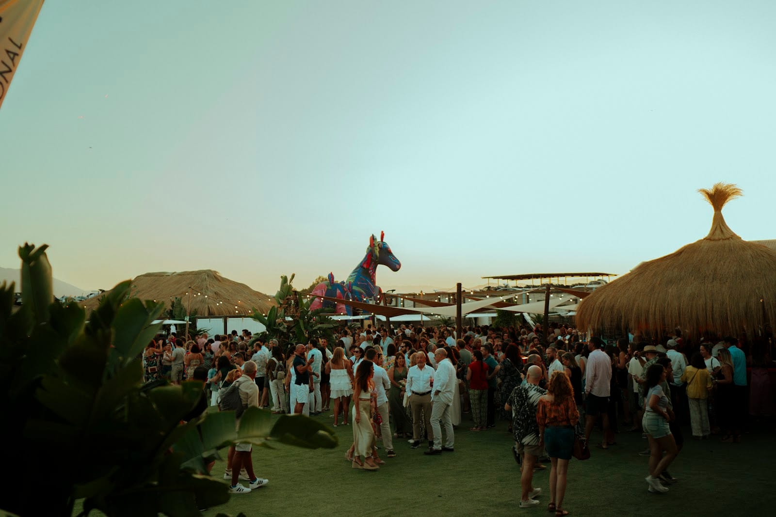 Outdoor festival with crowd and leisure areas at an event venue in Malaga