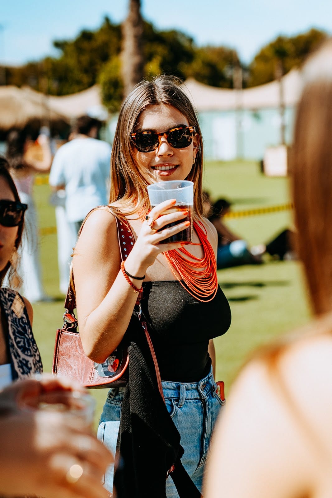 Guest enjoying an outdoor event at Málaga Forum with drink and social atmosphere