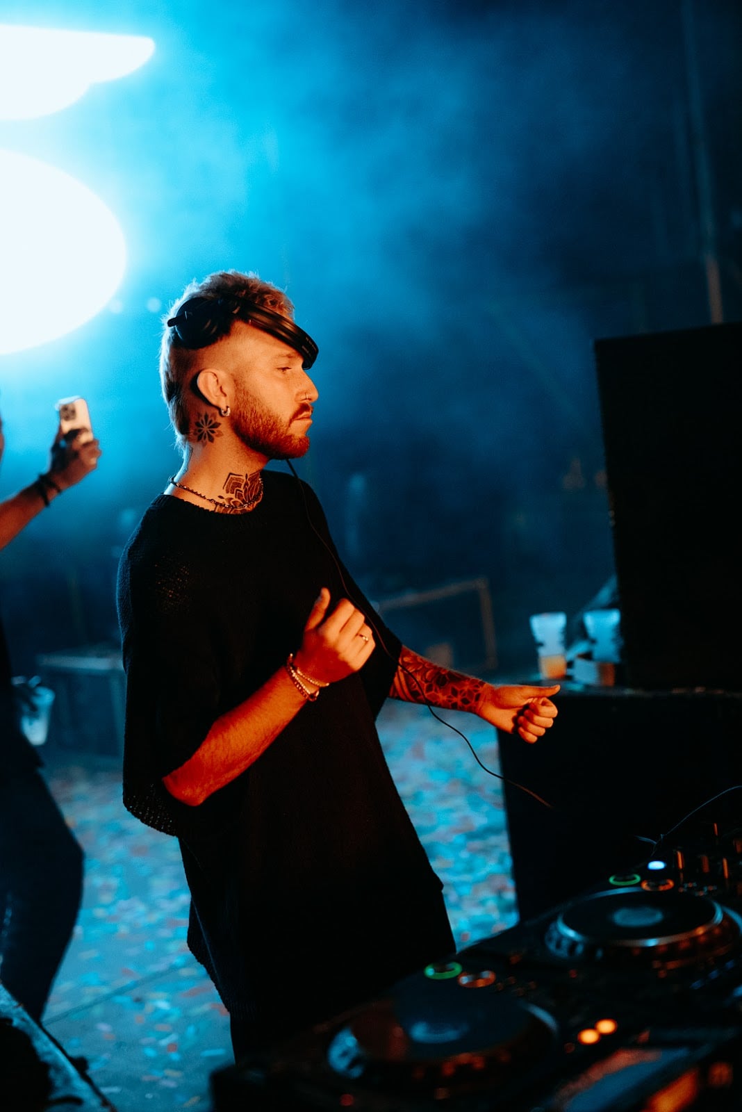 DJ performing at Málaga Forum with stage lighting, smoke effects and electronic music setup