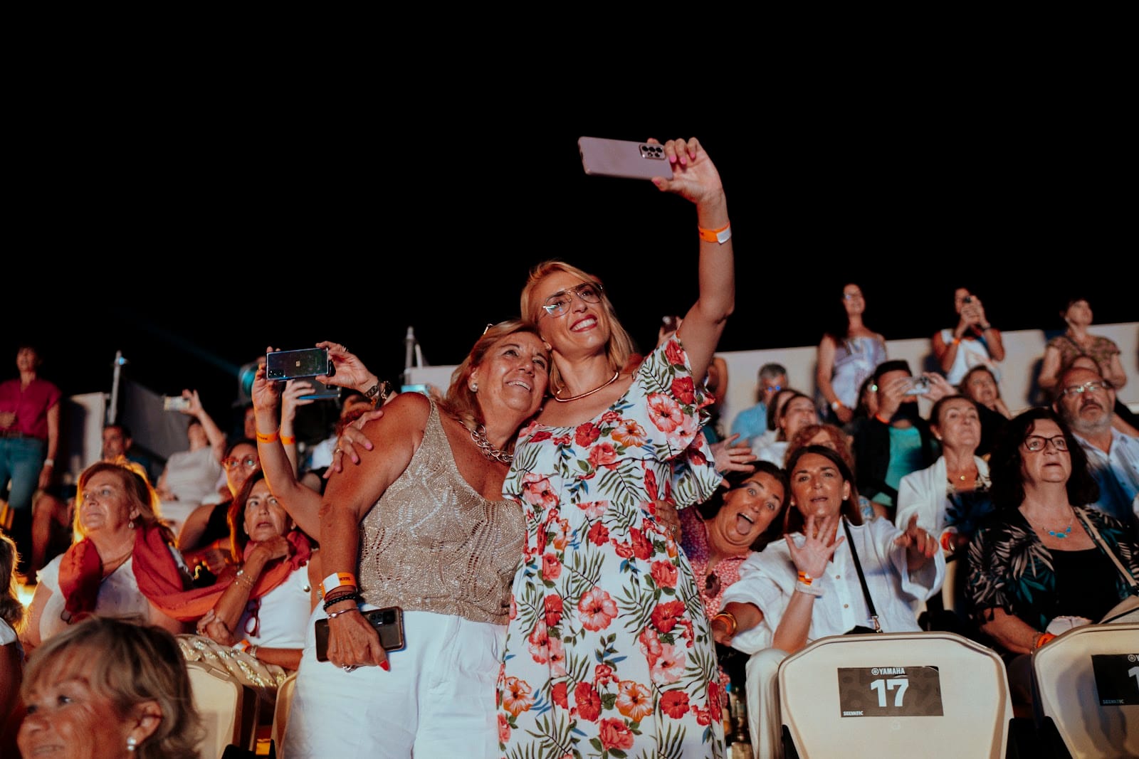 Audience enjoying a live event at Málaga Forum with guests taking photos and watching the show